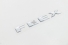 Emblema 'Flex' Pajero Tr4 (Resinado) Aço Escovado